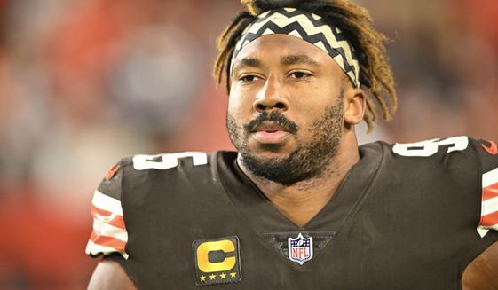 Cleveland Browns defensive end Myles Garrett (95) walks on the field during an NFL football game against the Pittsburgh Steelers, Sept. 22, 2022, in Cleveland. Garrett was released from a hospital late Monday, Sept. 26, after he was injured when he rolled over his Porsche while driving on a rural road following practice. (AP Photo/David Richard, File)