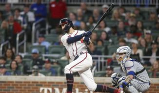 Atlanta Braves&#39; Dansby Swanson follows through on a single during the third inning of the team&#39;s baseball game against the New York Mets, Saturday, Oct. 1, 2022, in Atlanta. (AP Photo/Brett Davis)