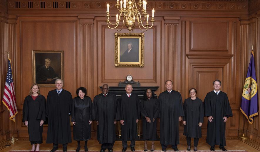 In this image provided by the Supreme Court, members of the Supreme Court pose for a photo during Associate Justice Ketanji Brown Jackson&#39;s formal investiture ceremony at the Supreme Court in Washington, Friday, Sept. 30, 2022. From left, Associate Justice Amy Coney Barrett, Associate Justice Neil Gorsuch, Associate Justice Sonia Sotomayor, Associate Justice Clarence Thomas, Chief Justice John Roberts, Associate Justice Ketanji Brown Jackson, Associate Justice Samuel Alito, Associate Justice Elena Kagan and Associate Justice Brett Kavanaugh. (Fred Schilling/U.S. Supreme Court via AP)