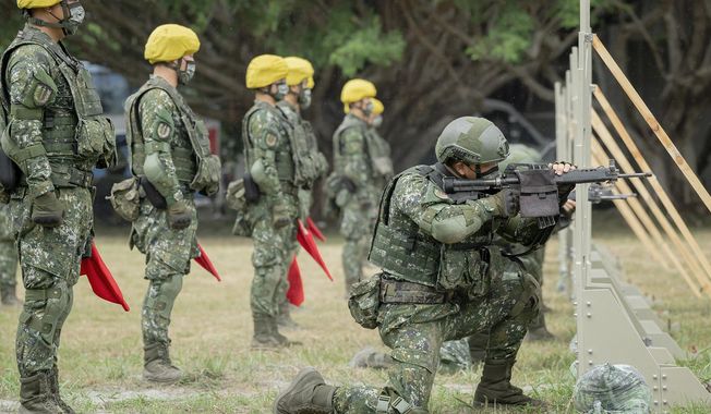 In this photo released by the Taiwan Presidential Office, Taiwanese soldiers go through a drill as Taiwan&#x27;s President Tsai Ing-wen visits a camp in Hualien, in eastern Taiwan on Tuesday, Sept. 6, 2022. Taiwanese President Tsai Ing-wen said Tuesday that China is conducting &amp;quot;cognitive warfare&amp;quot; by spreading misinformation in addition to its regular incursions into nearby waters and airspace intended at intimidating the self-governing island. (Taiwan Presidential Office via AP)