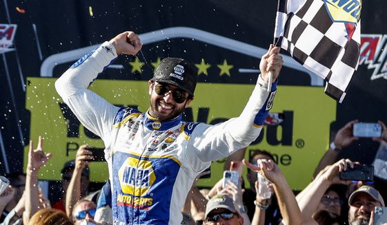 Chase Elliott celebrates in Victory Lane after winning a NASCAR Cup Series auto race, Sunday, Oct. 2, 2022, in Talladega, Ala. (AP Photo/Butch Dill)