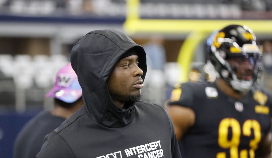 Washington Commanders injured running back Brian Robinson Jr. watches warmups before the first half of a NFL football game against the Dallas Cowboys in Arlington, Texas, Sunday, Oct. 2, 2022. (AP Photo/Michael Ainsworth) **FILE**