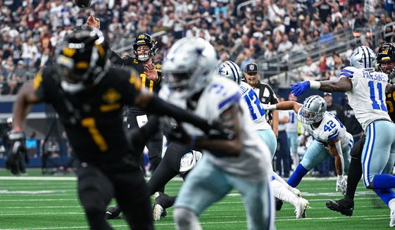 Washington Commanders quarterback Carson Wentz (11) throws a 10-yard touchdown pass to receiver Jahan Dotson (1) during the first half against the Dallas Cowboys at AT&amp;T Stadium, Arlington, Texas, October 2, 2022. (Photo by Brian Murphy)