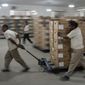 Electoral workers move electronic voting machine boxes at a distribution center in Rio de Janeiro, Brazil, Saturday, Oct. 1, 2022. Brazil&#39;s general elections are scheduled for Oct. 2. Brazilians head to polls on Oct. 2 to elect a president, vice president, governors and senators. (AP Photo/Matias Delacroix)