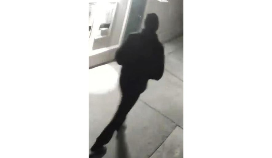 In this undated surveillance image released by the Stockton Police Department, a person is shown from behind, in Stockton, Calif. Rewards totaling $85,000 have been offered for information leading to an arrest in five fatal shootings since July in Stockton, California, that investigators believe are related, police said. After reviewing surveillance footage, detectives have located an unidentified “person of interest” in the killings, Stockton Police Chief Stanley McFadden wrote on the department’s Facebook page. Police released a grainy still image of an individual filmed from behind, dressed all in black and wearing a black cap.  (Stockton Police Department via AP)
