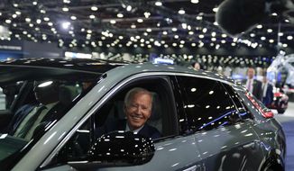 FILE - President Joe Biden drives a Cadillac Lyriq through the showroom during a tour at the Detroit Auto Show, Sept. 14, 2022, in Detroit. Biden, a self-described “car guy,&#39;&#39; often promises to lead by example by moving swiftly to convert the sprawling federal fleet to zero-emission electric vehicles. But efforts to help meet his ambitious climate goals by eliminating gas-powered vehicles from the federal fleet have lagged. (AP Photo/Evan Vucci, File)