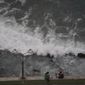 People relax at the beach front in Mazatlan, Mexico, Sunday, Oct. 2, 2022. Hurricane Orlene, at Category 3 strength, is heading for a collision with Mexico&#39;s northwest Pacific coast between the tourist towns of Mazatlan and San Blas. (AP Photo/Fernando Llano)