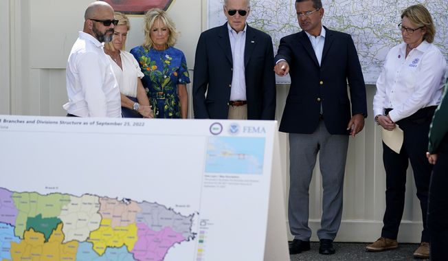 President Joe Biden and first lady Jill Biden, receive a briefing from Puerto Rico Gov. Pedro Pierluisi on Hurricane Fiona, Monday, Oct. 3, 2022, in Ponce, Puerto Rico. (AP Photo/Evan Vucci)