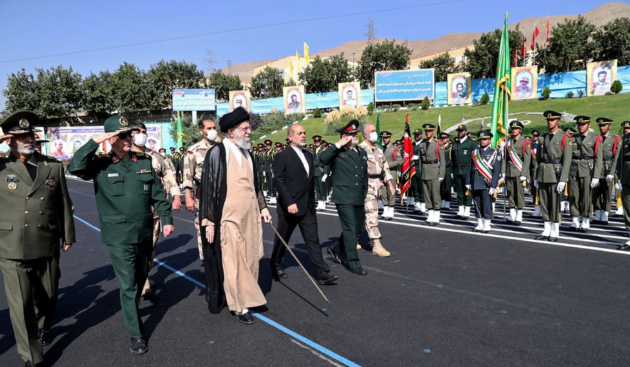 In this picture released by the official website of the office of the Iranian supreme leader, Supreme Leader Ayatollah Ali Khamenei, third left, reviews a group of armed forces cadets during their graduation ceremony accompanied by commanders of the armed forces, at the police academy in Tehran, Iran, Monday, Oct. 3, 2022. Khamenei responded publicly on Monday to the biggest protests in Iran in years, breaking weeks of silence to condemn what he called “rioting” and accuse the U.S. and Israel of planning the protests.  (Office of the Iranian Supreme Leader via AP)