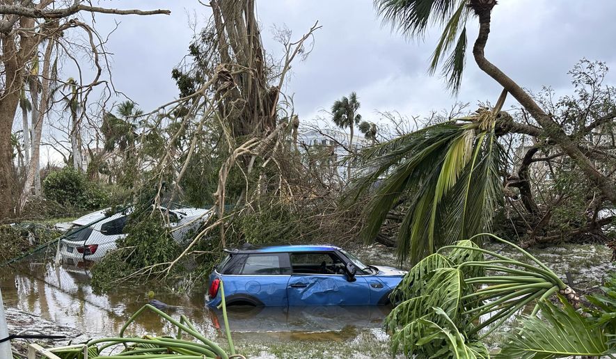 In this undated image from video, damaged vehicles and debris are seen on Sanibel Island, Fla. Chuck Larsen&#39;s home was slammed by Hurricane Ian and he spent a harrowing few days on the isolated island before being evacuated over the weekend. (Chuck Larsen/SantivaChronicle.com via AP)