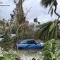 In this undated image from video, damaged vehicles and debris are seen on Sanibel Island, Fla. Chuck Larsen&#39;s home was slammed by Hurricane Ian and he spent a harrowing few days on the isolated island before being evacuated over the weekend. (Chuck Larsen/SantivaChronicle.com via AP)