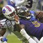 Baltimore Ravens quarterback Lamar Jackson (8) is brought down by Buffalo Bills linebacker Tremaine Edmunds in the second half of an NFL football game Sunday, Oct. 2, 2022, in Baltimore. (AP Photo/Julio Cortez) **FILE**