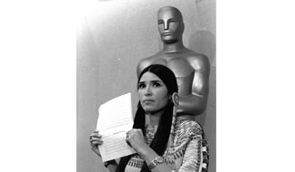 Sacheen Littlefeather, a Native American activist, tells the audience at the Academy Awards ceremony in Los Angeles, March 27, 1973, that Marlon Brando was declining to accept his Oscar as best actor for his role in &amp;quot;The Godfather.&amp;quot; Sacheen Littlefeather died Sunday, Oct. 2, 2022, at her home in Marin County, Calif. She was 75. (AP Photo/File)