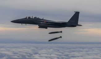 In this photo provided by South Korea Defense Ministry, South Korean Air Force&#39;s F15K fighter jet fires 2 JDAM (Joint Direct Attack Munition ) bombs into an island target in South Korea, Tuesday, Oct. 4, 2022. The South Korean and U.S. militaries responded to a North Korea morning missile launch by launching fighter jets which fired weapons at a target off South Korea&#39;s west coast in a show of strength against North Korea. (South Korea Defense Ministry via AP)