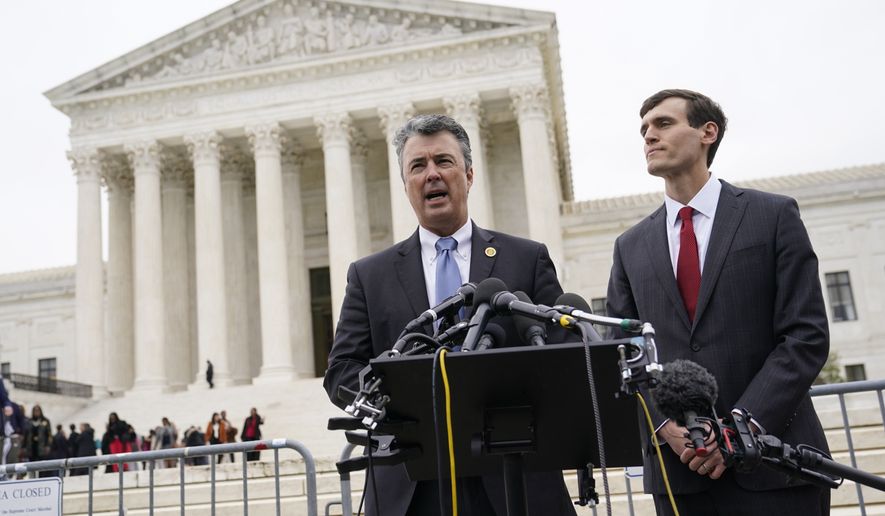 Alabama Attorney General Steve Marshall, left, speaks alongside Alabama Solicitor General Edmund LaCour following oral arguments in Merrill v. Milligan, an Alabama redistricting case that could have far-reaching effects on minority voting power across the United States, outside the Supreme Court on Capitol Hill in Washington, Tuesday, Oct. 4, 2022. (AP Photo/Patrick Semansky)