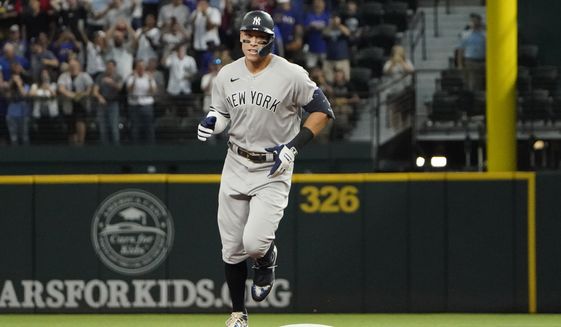 New York Yankees&#39; Aaron Judge rounds the bases after hitting a solo home run, his 62nd of the season, during the first inning in the second baseball game of a doubleheader against the Texas Rangers in Arlington, Texas, Tuesday, Oct. 4, 2022. With the home run, Judge set the AL record for home runs in a season, passing Roger Maris. (AP Photo/LM Otero)