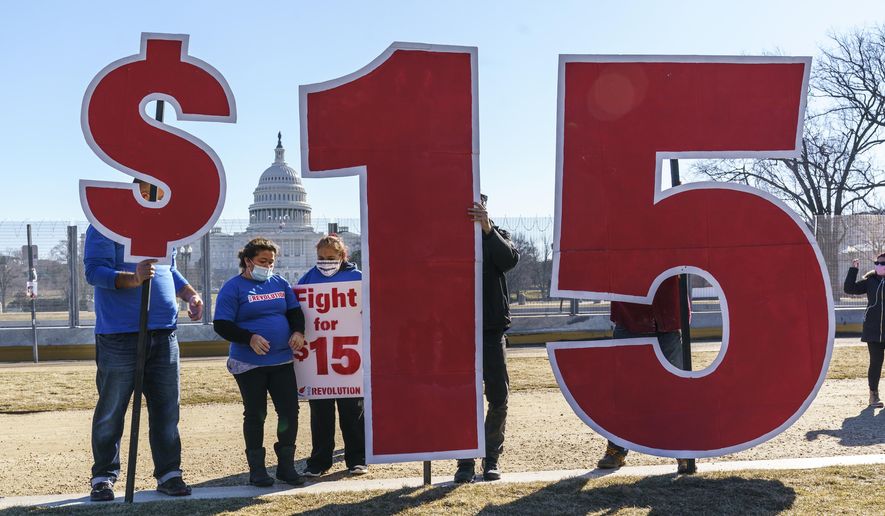 Activists appeal for a $15 minimum wage near the Capitol in Washington, Thursday, Feb. 25, 2021. According to the Economic Policy Institute, the federal minimum wage in 2021 was worth 34% less than in 1968, when its purchasing power peaked. (AP Photo/J. Scott Applewhite) **FILE**