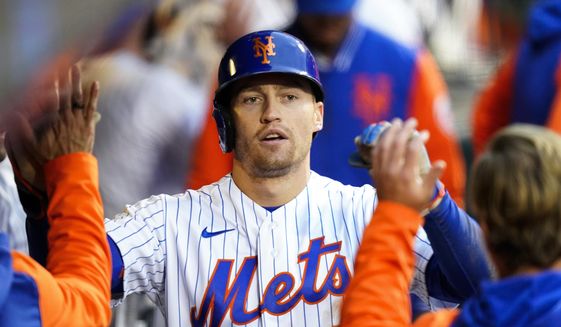 New York Mets&#39; Brandon Nimmo celebrates with teammates after hitting a home run during the fourth inning in the first baseball game of a doubleheader against the Washington Nationals, Tuesday, Oct. 4, 2022, in New York. (AP Photo/Frank Franklin II)