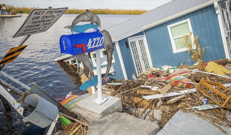 A residence sits partially submerged in water after Hurricane Ian leaves behind widespread damage across Pine Island, Fla., on Tuesday, Oct. 4, 2022. (Scott Clause/The News-Press via AP)