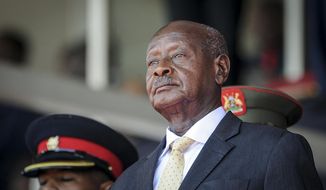 FILE - Uganda&#39;s President Yoweri Museveni attends the state funeral of Kenya&#39;s former president Daniel Arap Moi in Nairobi, Kenya on Feb. 11, 2020. Uganda&#39;s President Yoweri Museveni fired his son Muhoozi Kainerugaba as commander of the nation&#39;s infantry forces Tuesday, Oct. 4, 2022 after the son tweeted an unprovoked threat to capture the capital of neighboring Kenya, drawing widespread concern in East Africa. (AP Photo/John Muchucha, File)