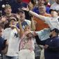 Fans reach for a foul ball by New York Yankees&#39; Aaron Judge during the second inning in the second baseball game of a doubleheader against the Texas Rangers in Arlington, Texas, Tuesday, Oct. 4, 2022. (AP Photo/LM Otero)
