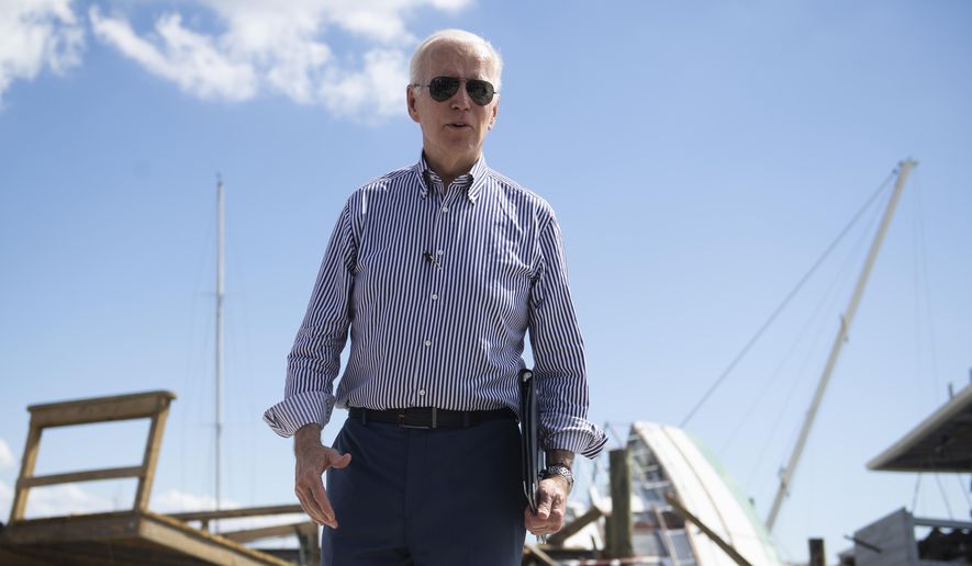 President Joe Biden visits Fisherman&#39;s Wharf in Fort Myers Beach, Fla., Wednesday, Oct. 5, 2022, to survey the damage caused by Hurricane Ian. (Saul Young/Knoxville News Sentinel via AP, Pool)
