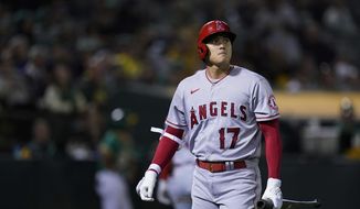 Los Angeles Angels&#39; Shohei Ohtani walks to the dugout after striking out against the Oakland Athletics during the eighth inning of a baseball game in Oakland, Calif., Tuesday, Oct. 4, 2022. (AP Photo/Godofredo A. Vásquez)