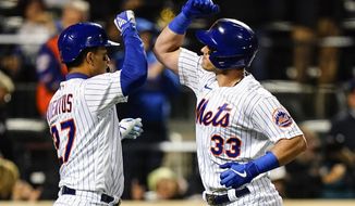 New York Mets&#x27; Mark Vientos celebrates with James McCann (33) after they scored on a three-run home run by McCann during the third inning of a baseball game against the Washington Nationals, Wednesday, Oct. 5, 2022, in New York. (AP Photo/Frank Franklin II)