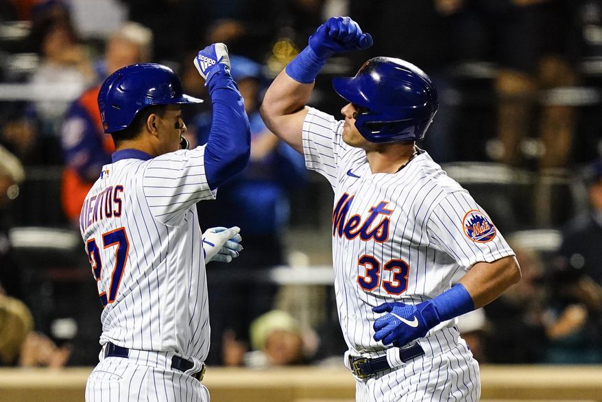New York Mets&#39; Mark Vientos celebrates with James McCann (33) after they scored on a three-run home run by McCann during the third inning of a baseball game against the Washington Nationals, Wednesday, Oct. 5, 2022, in New York. (AP Photo/Frank Franklin II)