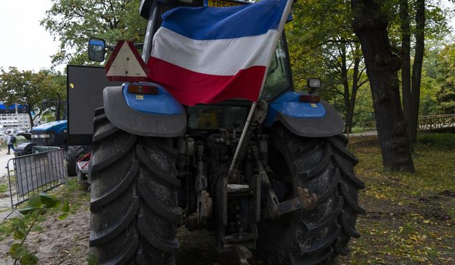 The Dutch flag flies upside down from a tractor during a small protest outside parliament, where Johan Remkes, an independent mediator, delivered his report into the Dutch government&#x27;s plans to drastically reduce emissions of nitrogen pollutants by the country&#x27;s agricultural sector during a press conference in The Hague, Netherlands, Wednesday, Oct. 5, 2022. The plans have sparked nationwide protests by angry farmers who fear for their livelihoods. (AP Photo/Peter Dejong)