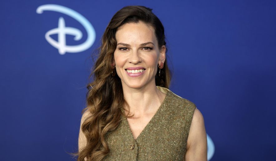 Hilary Swank attends the Disney 2022 Upfront presentation at Basketball City Pier 36 on May 17, 2022, in New York. Swank announced, Wednesday, Oct. 5, 2022, the she's pregnant with twins and says that revelation might explain some of her wardrobe alterations and other actions on set of her new ABC series “Alaska Daily.” (Photo by Charles Sykes/Invision/AP, File)