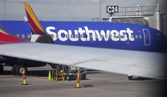 A Southwest Airlines jetliner sits at a gate on the C concourse of Denver International Airport on Wednesday, Oct. 6, 2021, in Denver.  A Southwest Airlines pilot is suing the company, her union and a former colleague who pleaded guilty last year to stripping naked in front of her during a flight, Wednesday, Oct. 5, 2022. C(AP Photo/David Zalubowski)