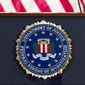 FILE - The FBI seal is displayed on a podium before a news conference at the agency&#39;s headquarters on June 14, 2018, in Washington. A U.S. senator is pressing the FBI for more information after a whistleblower alleged that an internal review found 665 FBI personnel have resigned or retired to avoid accountability in misconduct probes over the past two decades, according to a letter early from the senator early Oct. 2022. (AP Photo/Jose Luis Magana, File)