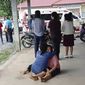 In this image taken from video, a distraught woman is comforted outside the site of an attack at a daycare canter, Thursday, Oct. 6, 2022, in the town of Nongbua Lamphu, north eastern Thailand. More than 30 people, primarily children, were killed Thursday when a gunman opened fire in the childcare center authorities said. (Mungkorn Sriboonreung Rescue Group via AP)