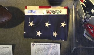 This image provided by Dan Vitale shows a U.S. flag signed by quarterback Tom Brady. Vitale, the owner of the flag, sued the New England Patriots on Wednesday, Oct. 5, 2022, saying the team caused irreparable damage to the flag by improperly displaying it at the team&#x27;s hall of fame at Gillette Stadium. The suit contends that after the flag had been on display for a couple of months, Brady’s signature written in blue Sharpie had significantly faded, which reduced the flag’s value by as much as $1 million. (Dan Vitale via AP)