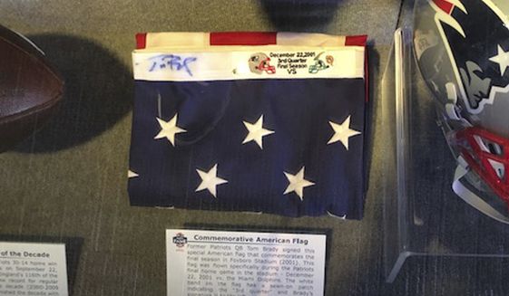 This image provided by Dan Vitale shows a U.S. flag signed by quarterback Tom Brady. Vitale, the owner of the flag, sued the New England Patriots on Wednesday, Oct. 5, 2022, saying the team caused irreparable damage to the flag by improperly displaying it at the team&#39;s hall of fame at Gillette Stadium. The suit contends that after the flag had been on display for a couple of months, Brady’s signature written in blue Sharpie had significantly faded, which reduced the flag’s value by as much as $1 million. (Dan Vitale via AP)