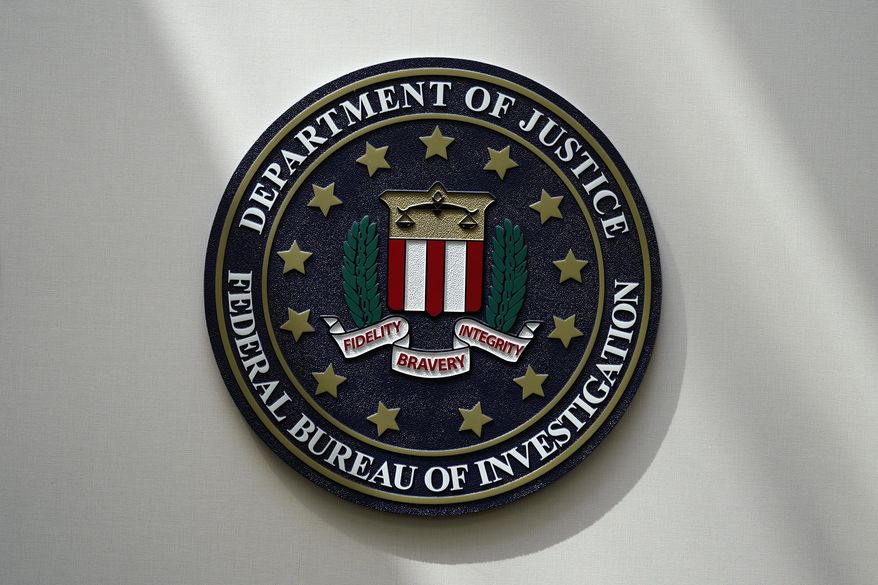 An FBI seal is seen on a wall on Aug. 10, 2022, in Omaha, Neb. The FBI estimates violent crime rates didn’t increase substantially last year, though they remained above pre-pandemic levels, according to annual crime data released Wednesday, Oct. 6. (AP Photo/Charlie Neibergall, File)