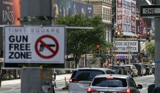 A sign reading &quot;Gun Free Zone&quot; is posted near Times Square in New York on Aug. 31, 2022. A federal judge said New York gun rules that dramatically restrict where people can carry weapons and require concealed carry permit applicants to hand over social media information should be put on hold, Thursday, Oct. 6, 2022. (AP Photo/Yuki Iwamura) **FILE**