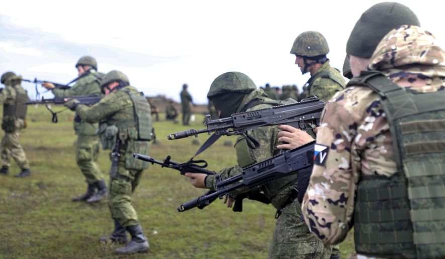 Russian Army recruits hold their weapons during a military training at a firing range in Donetsk People&#x27;s Republic controlled by Russia-backed separatists, eastern Ukraine, on Oct. 4, 2022. Russian Defense Minister Sergei Shoigu said that the military has recruited over 200,000 reservists as part of a partial mobilization launched two weeks ago. (AP Photo, File)