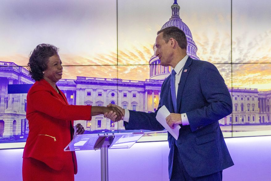 Republican candidate for U.S. Senate, U.S. Rep. Ted Budd, R-N.C., and Democratic challenger Cheri Beasley, shake hands after their televised debate, Friday, Oct. 7, 2022, at Spectrum News 1 studio in Raleigh, N.C. (Travis Long/The News &amp; Observer via AP, Pool)