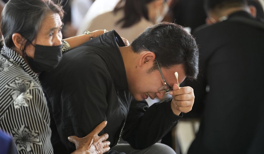 Seksan Sriraj, 28, grieves during a ceremony for those killed in the attack on the Young Children&#x27;s Development Center in the rural town of Uthai Sawan, north eastern Thailand, Friday, Oct. 7, 2022. Seksan lost his pregnant wife who was a teacher at the day care center when it was attacked by a former policeman Thursday. (AP Photo/Sakchai Lalit)