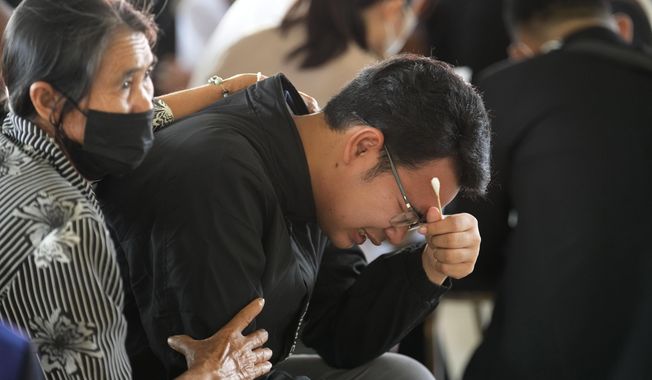 Seksan Sriraj, 28, grieves during a ceremony for those killed in the attack on the Young Children&#x27;s Development Center in the rural town of Uthai Sawan, north eastern Thailand, Friday, Oct. 7, 2022. Seksan lost his pregnant wife who was a teacher at the day care center when it was attacked by a former policeman Thursday. (AP Photo/Sakchai Lalit)
