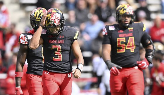 Maryland quarterback Taulia Tagovailoa, left, reacts after throwing an interception against Purdue in the first half of an NCAA college football game, Saturday, Oct. 8, 2022, in College Park, Md. (AP Photo/Gail Burton)