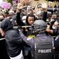 Police and protesters converge during a demonstration, Wednesday, Sept. 23, 2020, in Louisville, Ky. (AP Photo/John Minchillo, File)