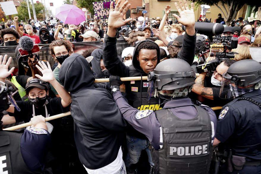 Police and protesters converge during a demonstration, Wednesday, Sept. 23, 2020, in Louisville, Ky. (AP Photo/John Minchillo, File)