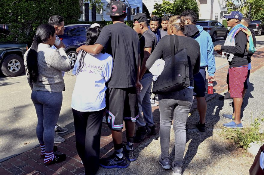 A group of immigrants gather outside St. Andrews Episcopal Church, Thursday Sept. 15, 2022, in Edgartown, Mass., on Martha's Vineyard. Florida officials began planning to transport migrants to other states in July and told potential contractors their task would be to relocate them on a voluntary basis, according to state documents released Friday, Oct. 7. (Ron Schloerb/The Cape Cod Times via AP, File)