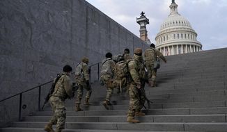 National Guard members take a staircase toward the U.S. Capitol building before a rehearsal for President-elect Joe Biden&#39;s Presidential Inauguration in Washington, Jan. 18, 2021. Soldiers are leaving the Army National Guard at a faster rate than they are enlisting, fueling concerns that in the coming years units around the country may not meet military requirements for overseas and other deployments. Officials say the number of soldiers retiring or leaving the Guard each month in the past year has exceeded those coming in, for a total annual loss of about 7,500 service members. (AP Photo/Patrick Semansky, File)