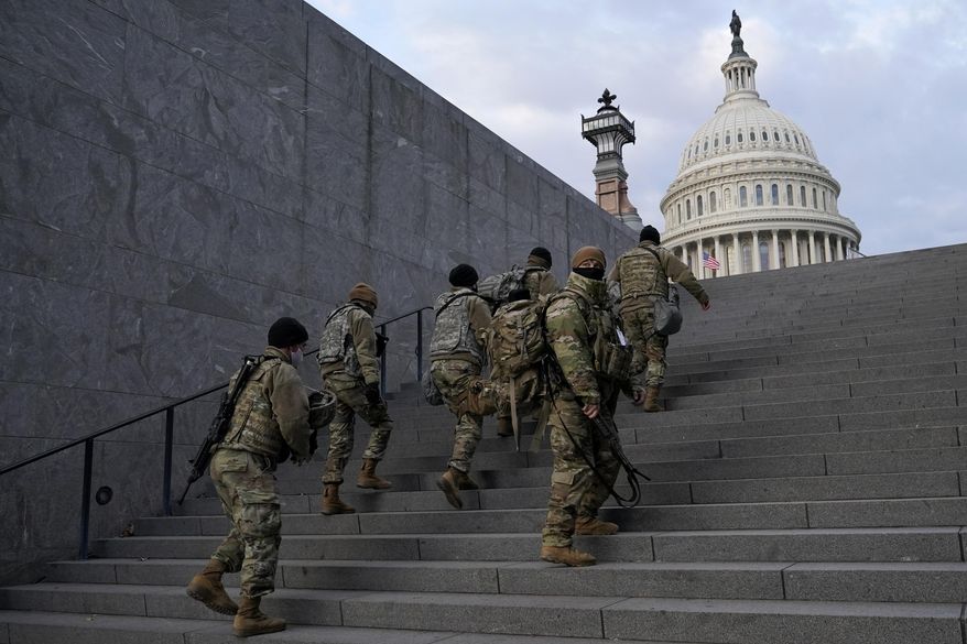 National Guard members take a staircase toward the U.S. Capitol building before a rehearsal for President-elect Joe Biden&#x27;s Presidential Inauguration in Washington, Jan. 18, 2021. Soldiers are leaving the Army National Guard at a faster rate than they are enlisting, fueling concerns that in the coming years units around the country may not meet military requirements for overseas and other deployments. Officials say the number of soldiers retiring or leaving the Guard each month in the past year has exceeded those coming in, for a total annual loss of about 7,500 service members. (AP Photo/Patrick Semansky, File)