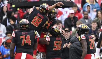 Maryland quarterback Taulia Tagovailoa (3) celebrates his touchdown with C.J. Dipre and other teammates in the first half of an NCAA college football game against Purdue, Saturday, Oct. 8, 2022, in College Park, Md. (AP Photo/Gail Burton)