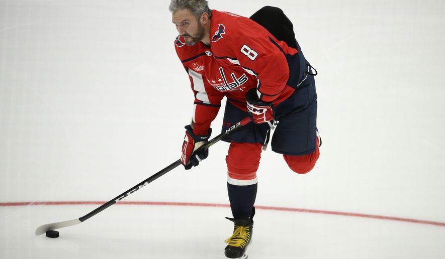 Washington Capitals left wing Alex Ovechkin (8) warms up before a preseason NHL hockey game against the Columbus Blue Jackets, Saturday, Oct. 8, 2022, in Washington. (AP Photo/Nick Wass)